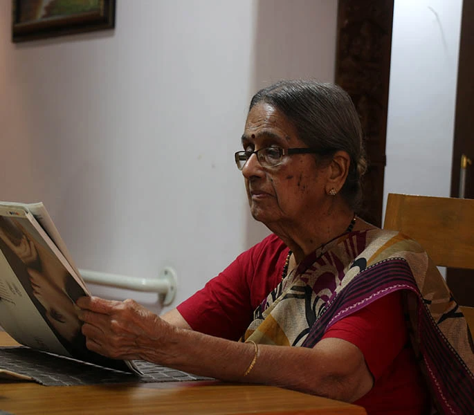 elder woman reading newspaper